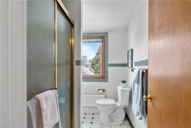 full bath featuring radiator, toilet, and a stall shower