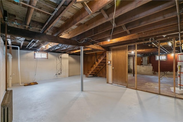below grade area featuring stairway, radiator, and electric panel