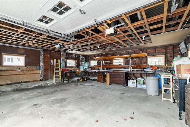 garage with a garage door opener and a workshop area