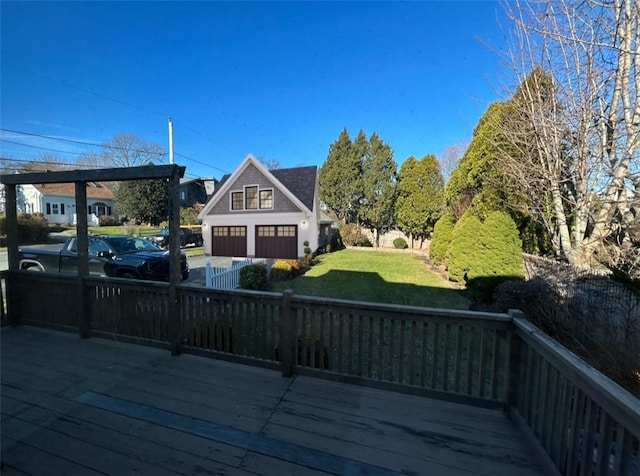 wooden deck with a yard and a garage