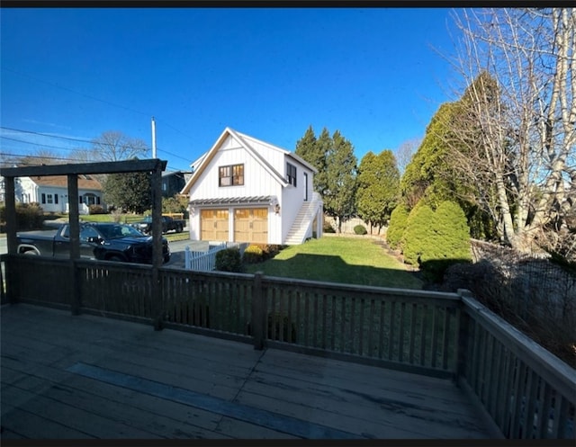 wooden deck featuring a lawn