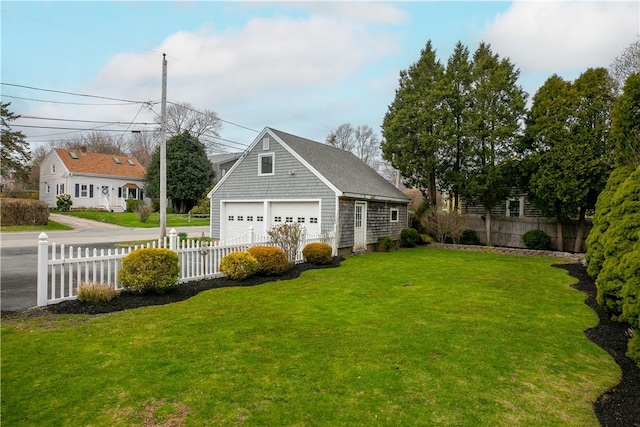 view of yard with fence and a detached garage