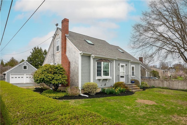 view of front of property with a garage, a chimney, an outdoor structure, fence, and a front yard