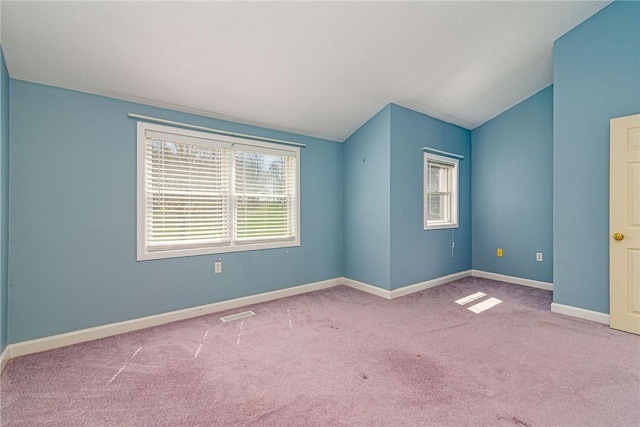 unfurnished room with lofted ceiling, baseboards, and carpet flooring