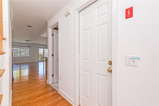 hall featuring baseboards and light wood finished floors