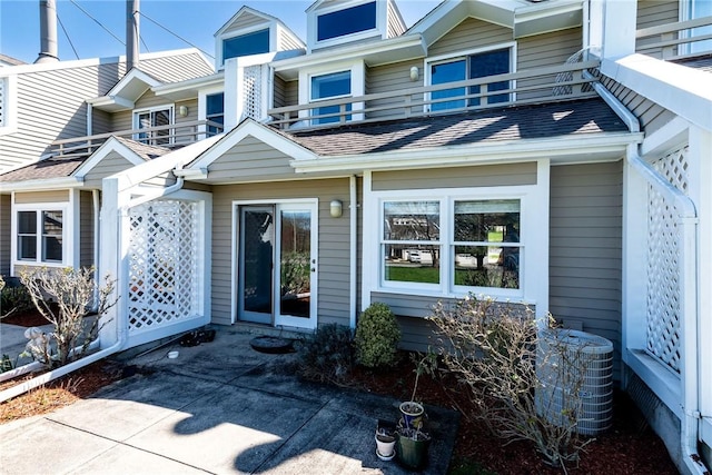 doorway to property with a balcony and cooling unit