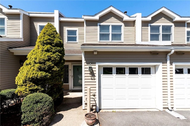 townhome / multi-family property featuring an attached garage and driveway
