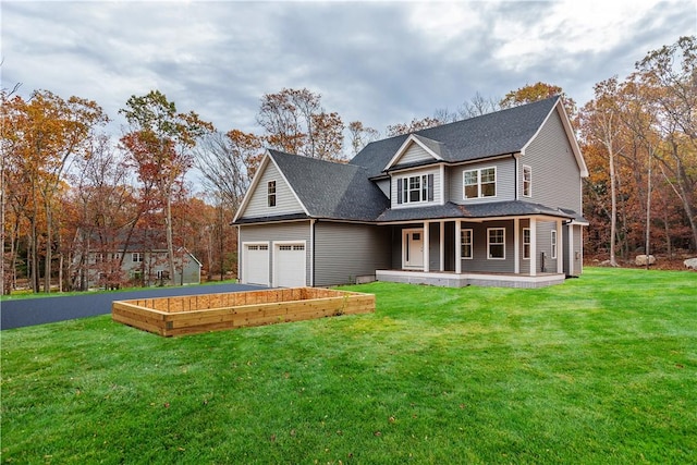 traditional-style home with a garage, a porch, a front yard, and a shingled roof