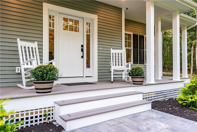 view of exterior entry featuring a porch