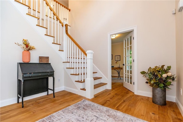 stairs with wood finished floors and baseboards