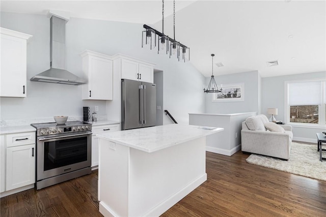kitchen with wall chimney range hood, vaulted ceiling, stainless steel appliances, white cabinetry, and dark wood-type flooring