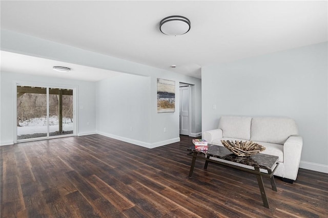 living area with baseboards and wood finished floors