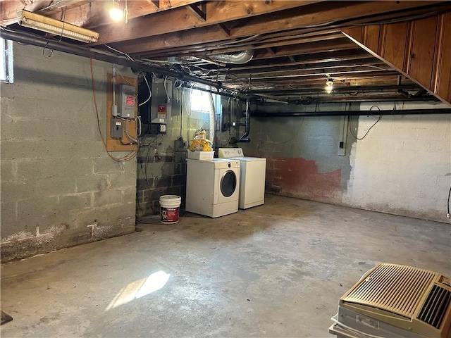 basement featuring washer and clothes dryer and electric panel