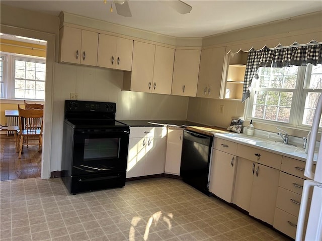 kitchen featuring black appliances, light floors, ceiling fan, light countertops, and cream cabinetry