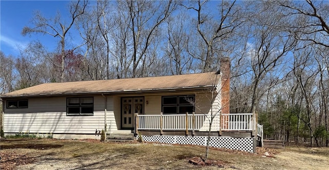 view of front of home featuring a porch and a chimney