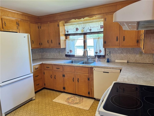 kitchen featuring a sink, light countertops, white appliances, and wall chimney exhaust hood
