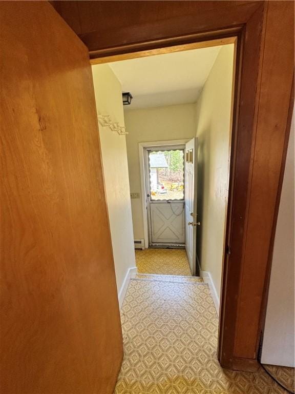 hall with light floors and baseboards