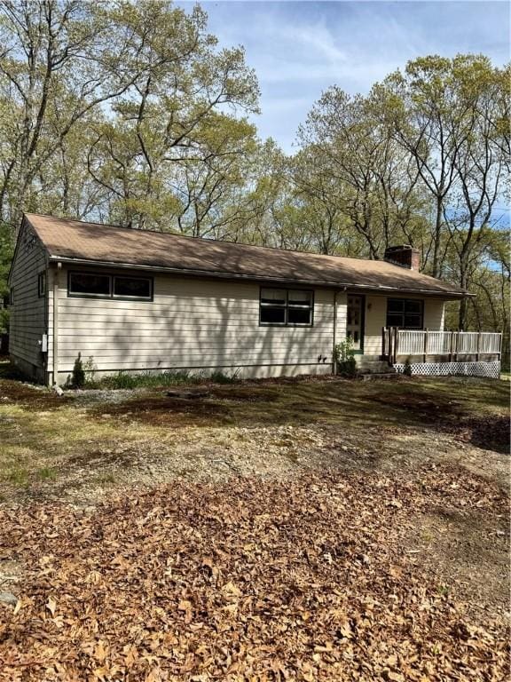 view of front of property featuring covered porch and a chimney