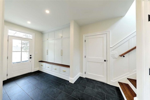 mudroom featuring recessed lighting and dark tile patterned floors