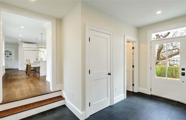 entryway with a healthy amount of sunlight, recessed lighting, and baseboards