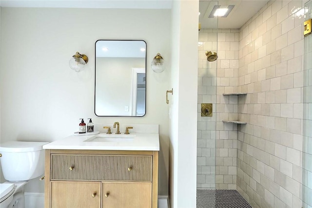 full bath with toilet, a tile shower, and vanity