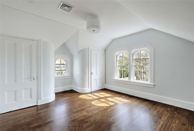 bonus room with baseboards, visible vents, wood finished floors, and lofted ceiling