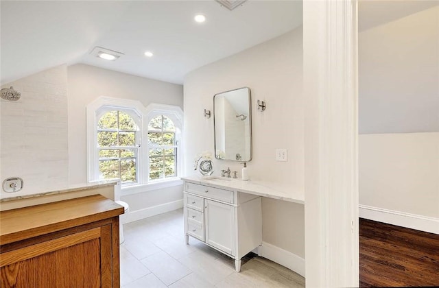 bathroom featuring a shower, baseboards, recessed lighting, vaulted ceiling, and vanity