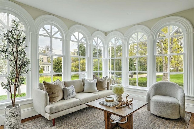 sunroom with wood finished floors and baseboards