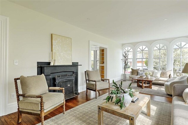 living room featuring baseboards and dark wood finished floors