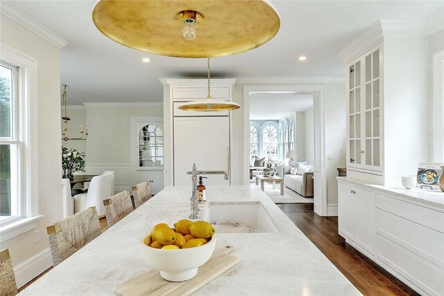 dining room with recessed lighting, ornamental molding, and dark wood-style flooring