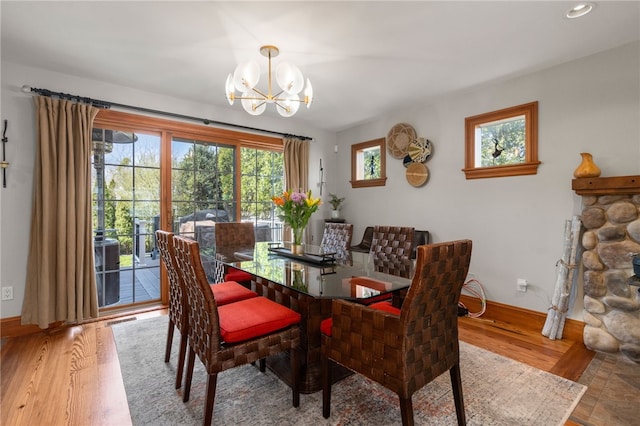 dining area featuring wood finished floors, baseboards, an inviting chandelier, and recessed lighting