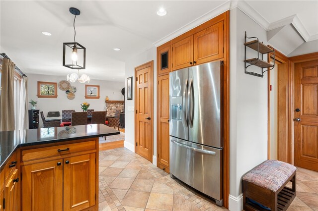 kitchen featuring brown cabinets, recessed lighting, baseboards, and stainless steel fridge