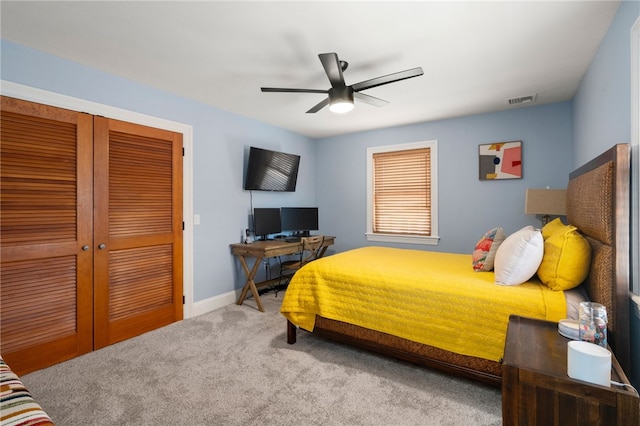 carpeted bedroom featuring ceiling fan, baseboards, visible vents, and a closet