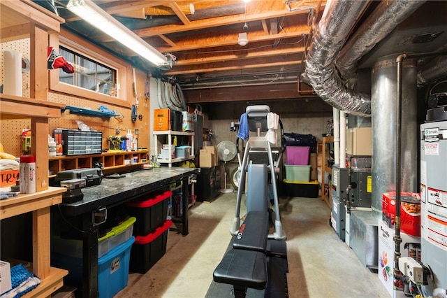 unfinished basement featuring water heater and a workshop area