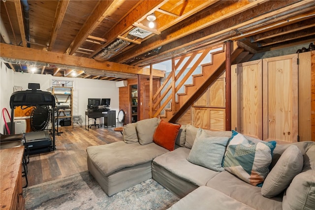 living area featuring stairway and wood finished floors