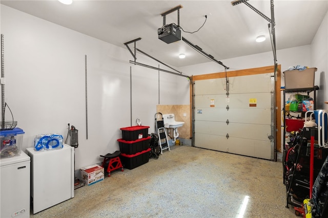 garage featuring independent washer and dryer and a garage door opener