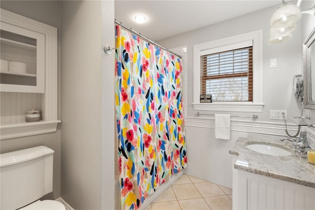 full bathroom with tile patterned floors, a shower with curtain, toilet, tile walls, and vanity