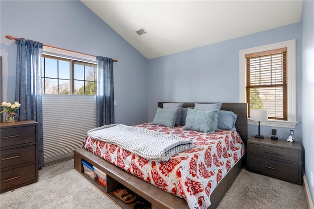bedroom with lofted ceiling, carpet flooring, and visible vents