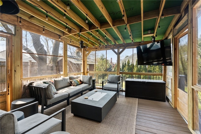 sunroom featuring a wealth of natural light and an outdoor living space