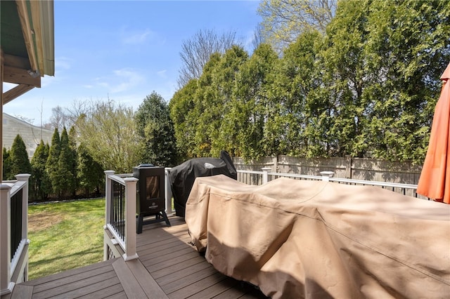 deck with fence, grilling area, and a yard