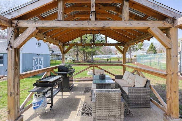 view of patio / terrace featuring fence, grilling area, a gazebo, and a shed