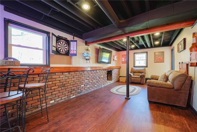 bar featuring brick wall and wood finished floors