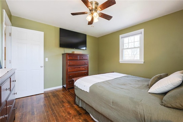 bedroom with a ceiling fan, baseboards, and dark wood-type flooring