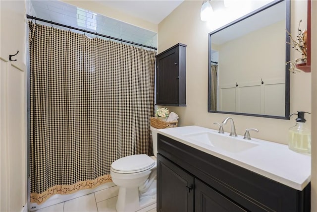 bathroom featuring curtained shower, tile patterned flooring, vanity, and toilet