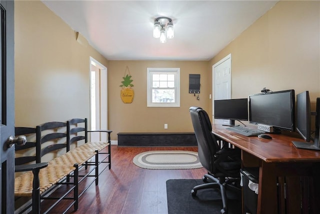 home office with baseboards and wood finished floors