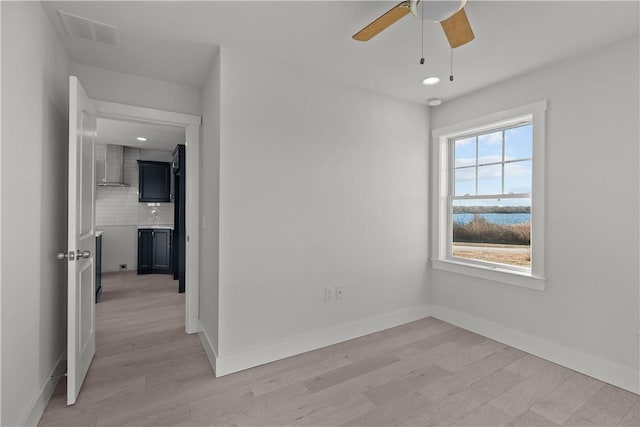 empty room with recessed lighting, visible vents, light wood-style floors, baseboards, and ceiling fan