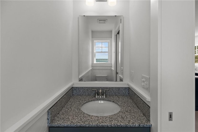 half bathroom with visible vents and vanity