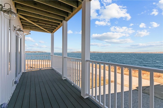 wooden terrace featuring a water view