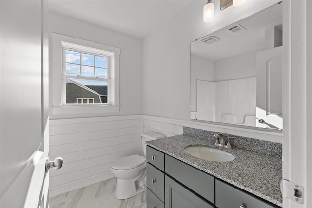 bathroom featuring wainscoting, vanity, marble finish floor, toilet, and visible vents