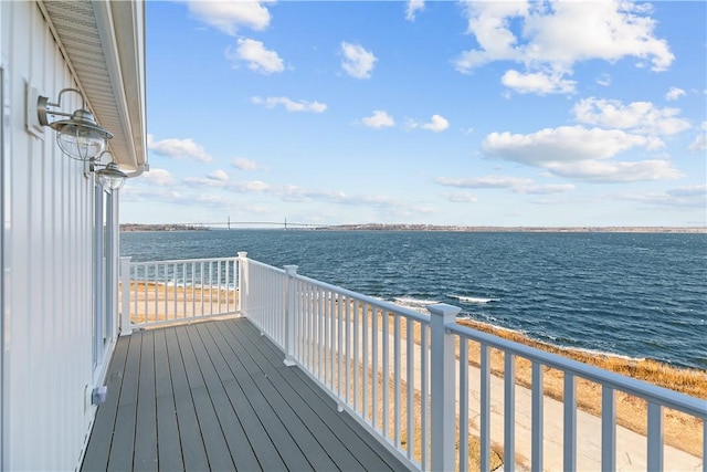 wooden terrace featuring a water view